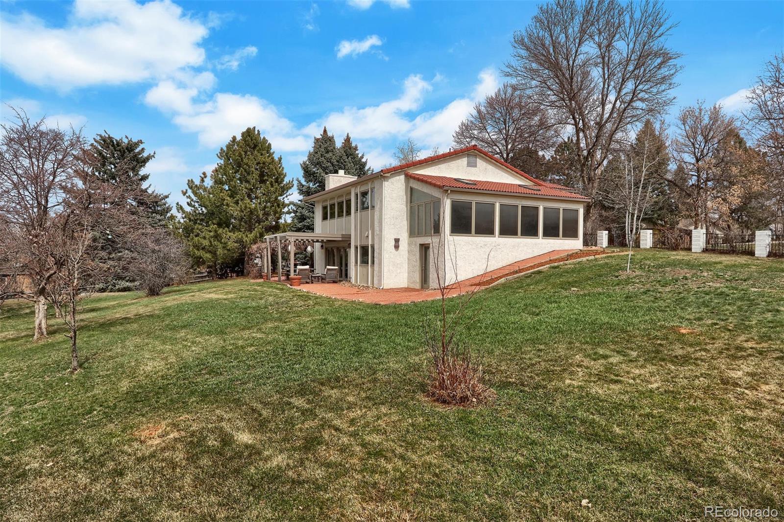 855 Front Range Road Littleton, CO 80120 - Photo 30 of 34 a front view of a house with a yard