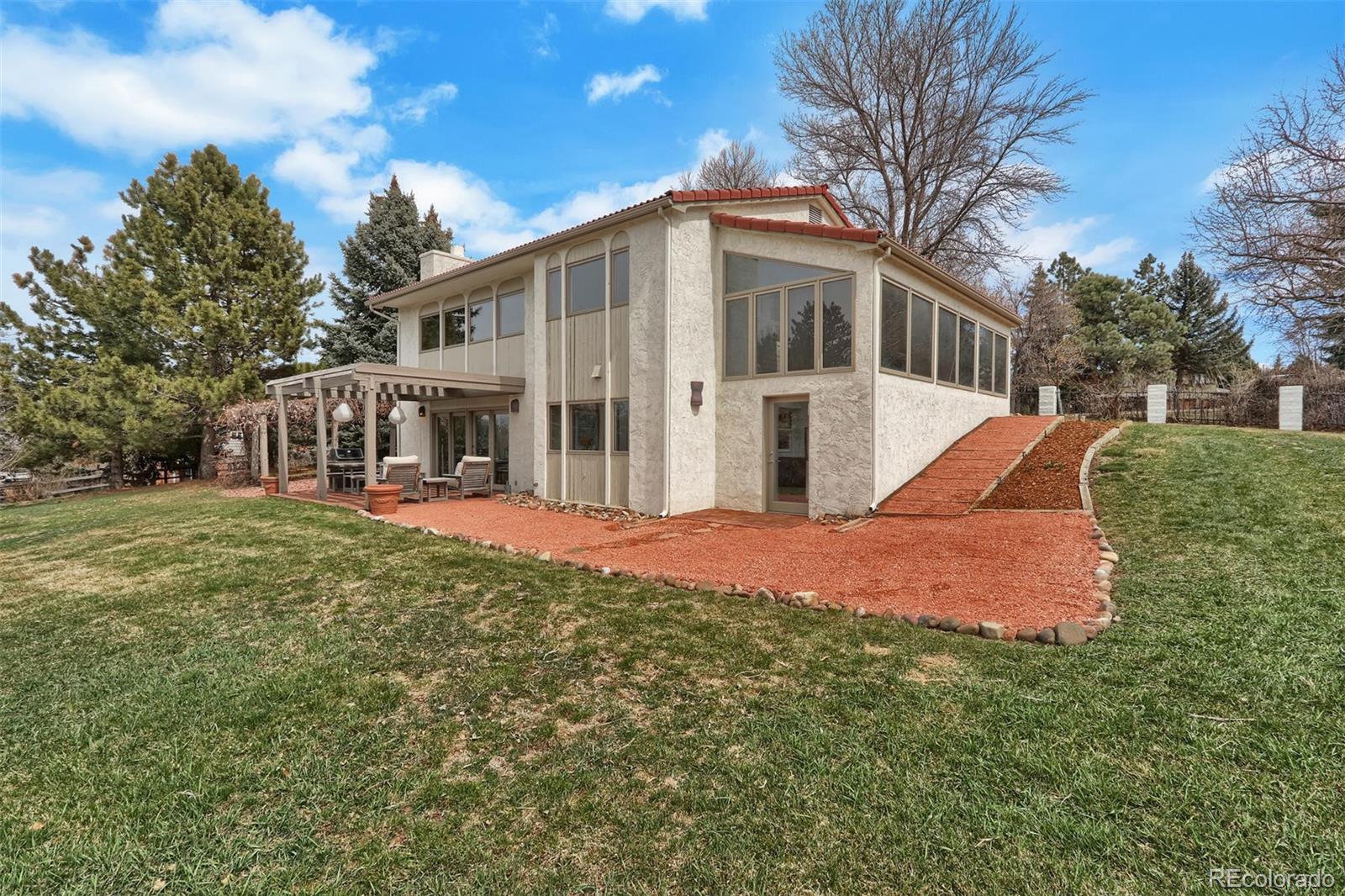 855 Front Range Road Littleton, CO 80120 - Photo 31 of 34 a view of a house with a yard