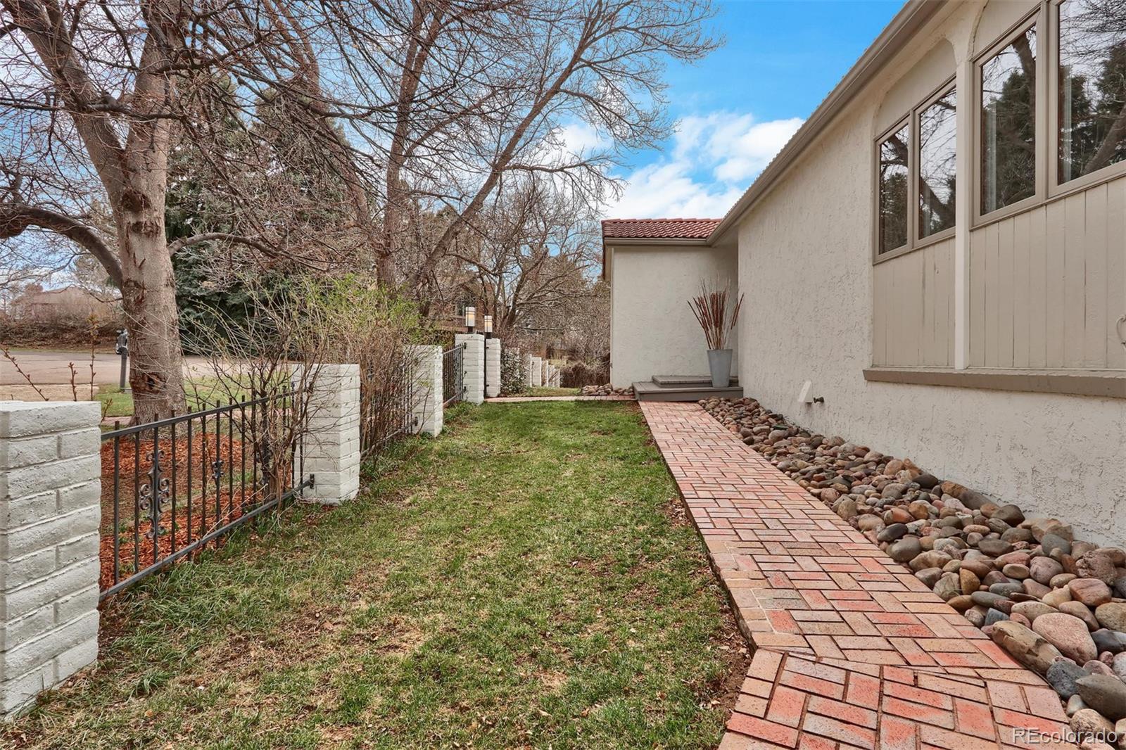 855 Front Range Road Littleton, CO 80120 - Photo 32 of 34 a front view of a house with garden