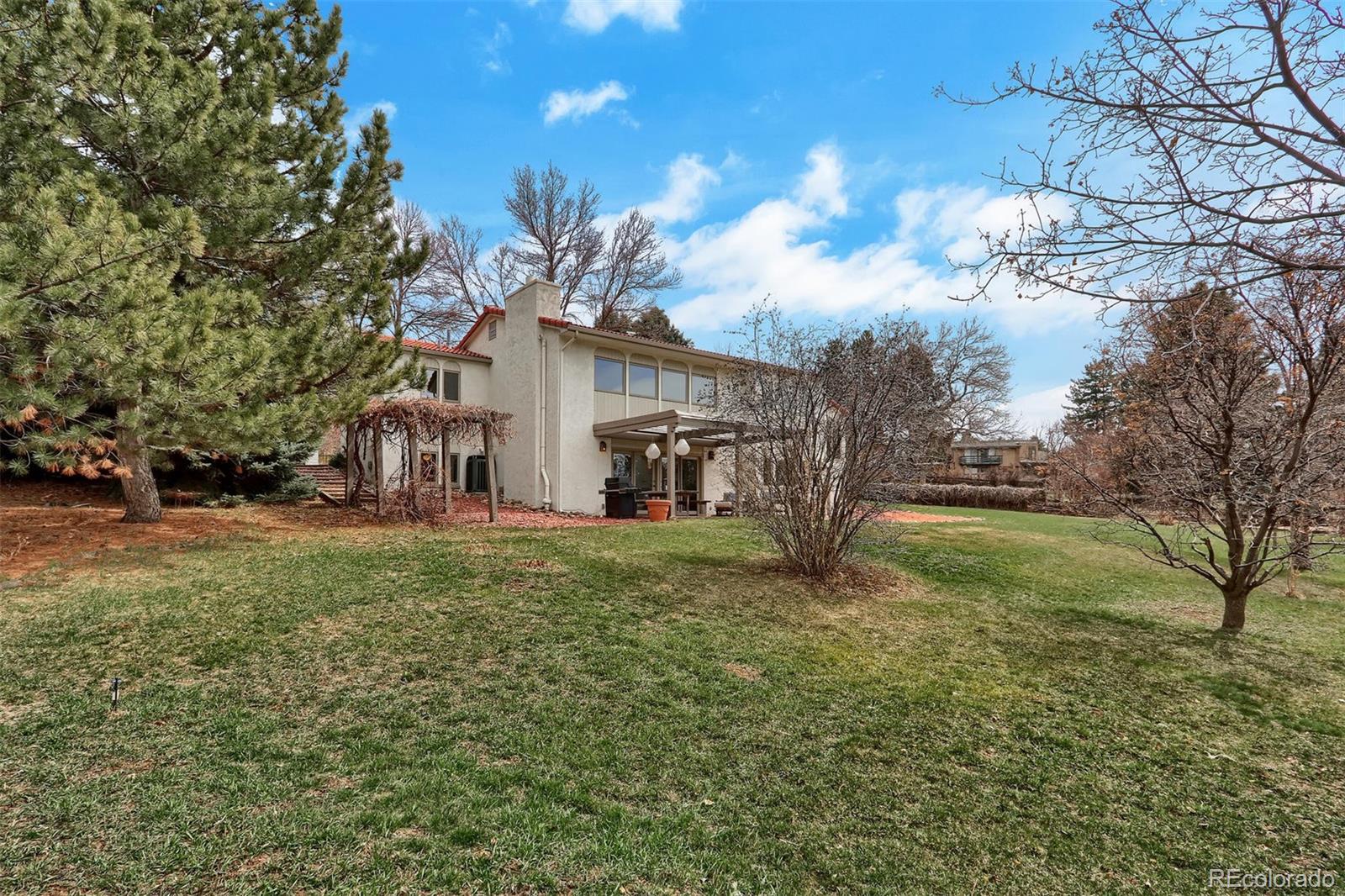 855 Front Range Road Littleton, CO 80120 - Photo 33 of 34 a view of a house with a yard
