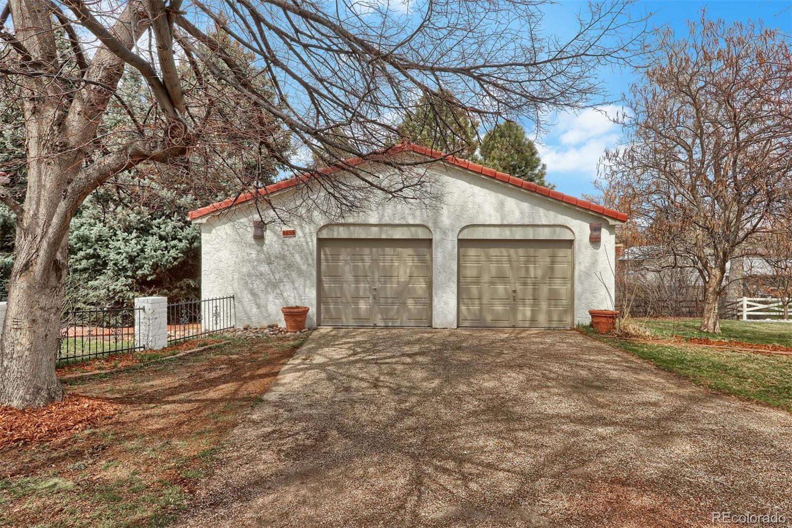 855 Front Range Road Littleton, CO 80120 - Photo 34 of 34 a front view of a house with a large trees