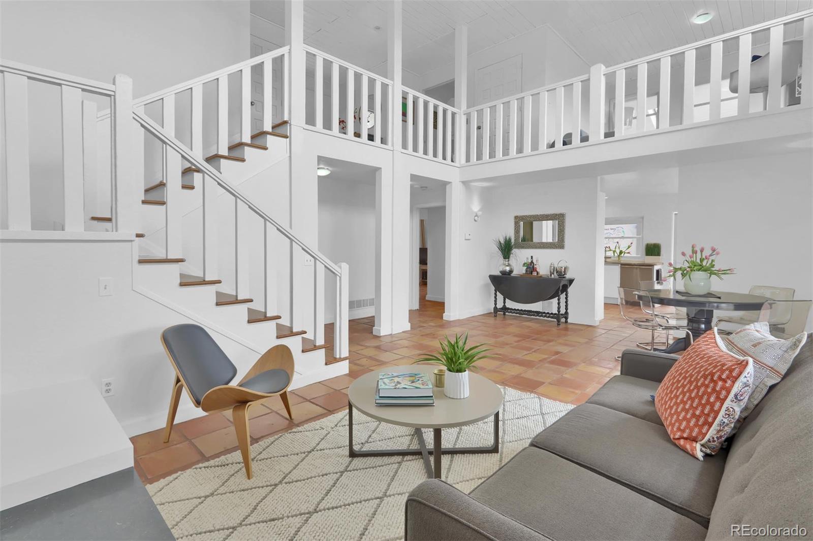 855 Front Range Road Littleton, CO 80120 - Photo 7 of 34 a living room with furniture and a book shelf