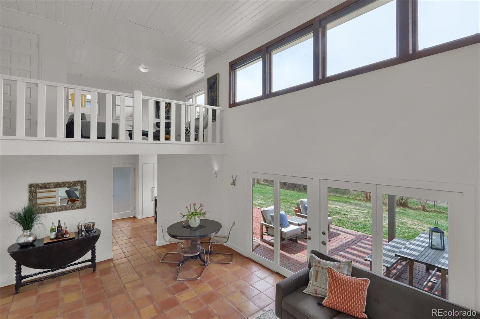 855 Front Range Road Littleton, CO 80120 - Photo 8 of 34 a living room with furniture fireplace and large windows