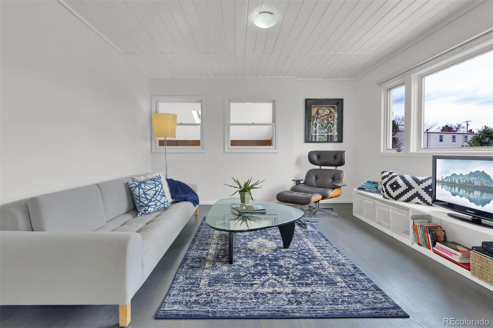855 Front Range Road Littleton, CO 80120 - Photo 9 of 34 a living room with furniture and a rug