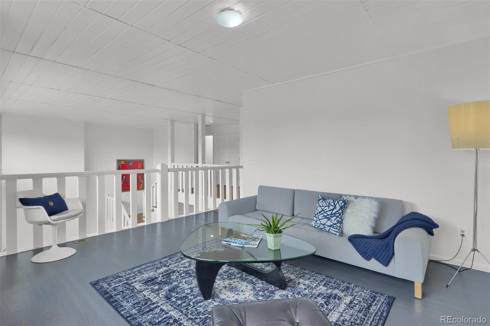 855 Front Range Road Littleton, CO 80120 - Photo 10 of 34 a living room with furniture and a rug