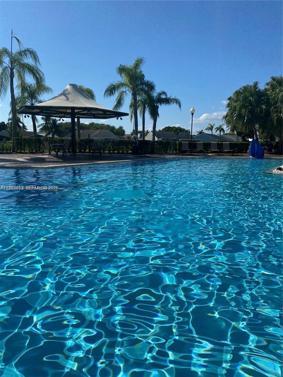540 Southeast 21st Lane, Unit 540 Homestead, FL 33033 - Photo 14 of 14 a front view of a house with garden