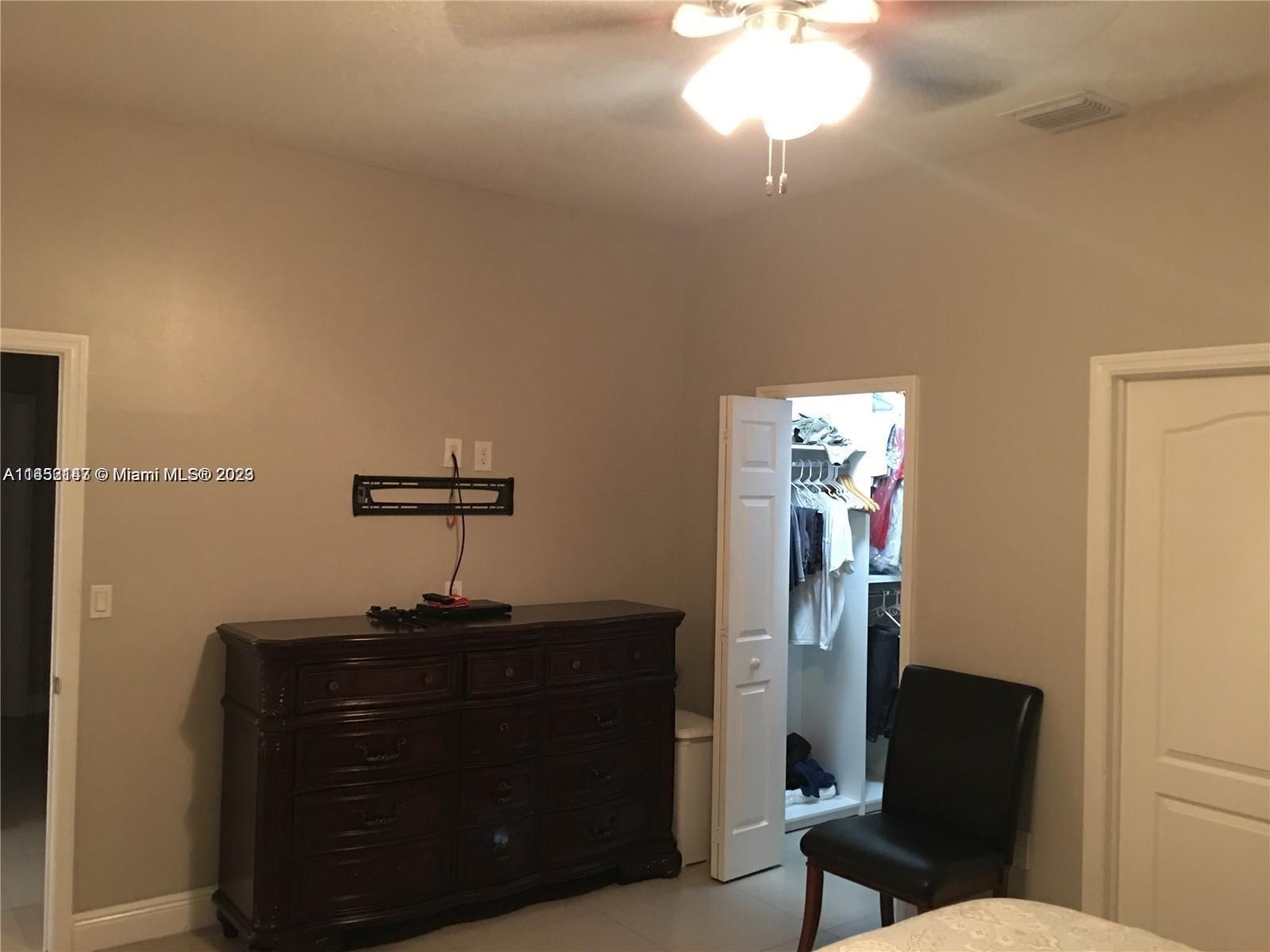 16124 Southwest 55th Terrace Miami, FL 33185 - Photo 12 of 23 a room with a window and a chair