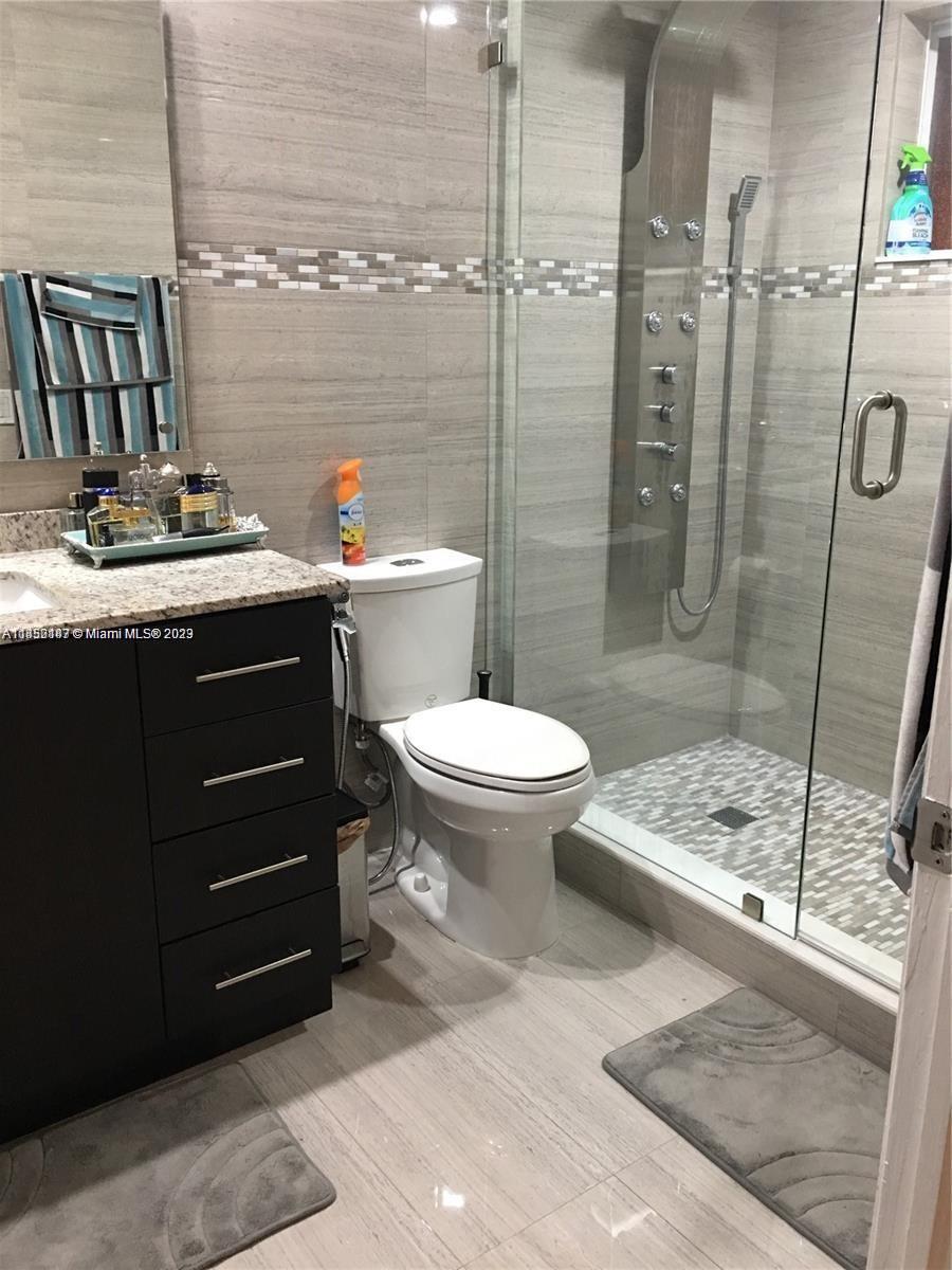 16124 Southwest 55th Terrace Miami, FL 33185 - Photo 14 of 23 a bathroom with a sink a toilet and shower