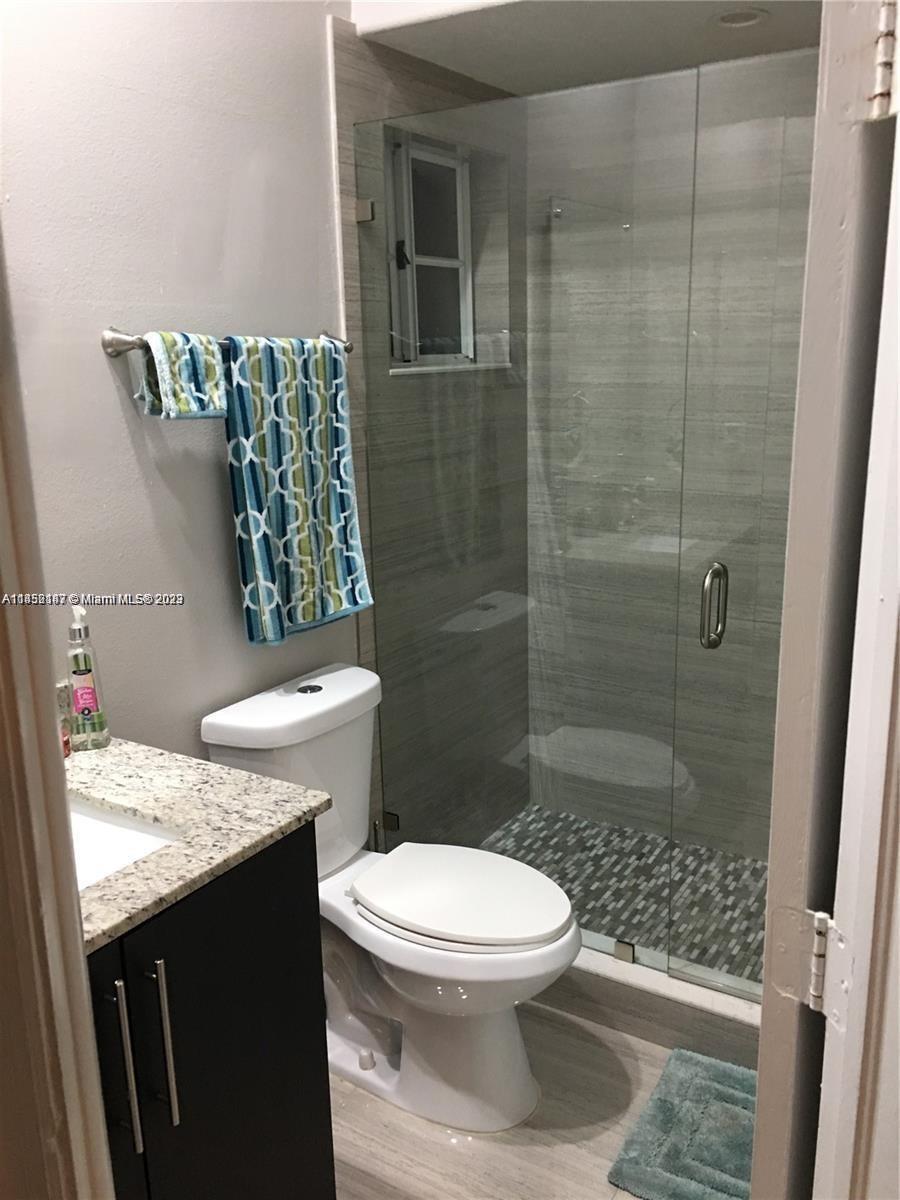 16124 Southwest 55th Terrace Miami, FL 33185 - Photo 16 of 23 a bathroom with a granite countertop toilet and a shower