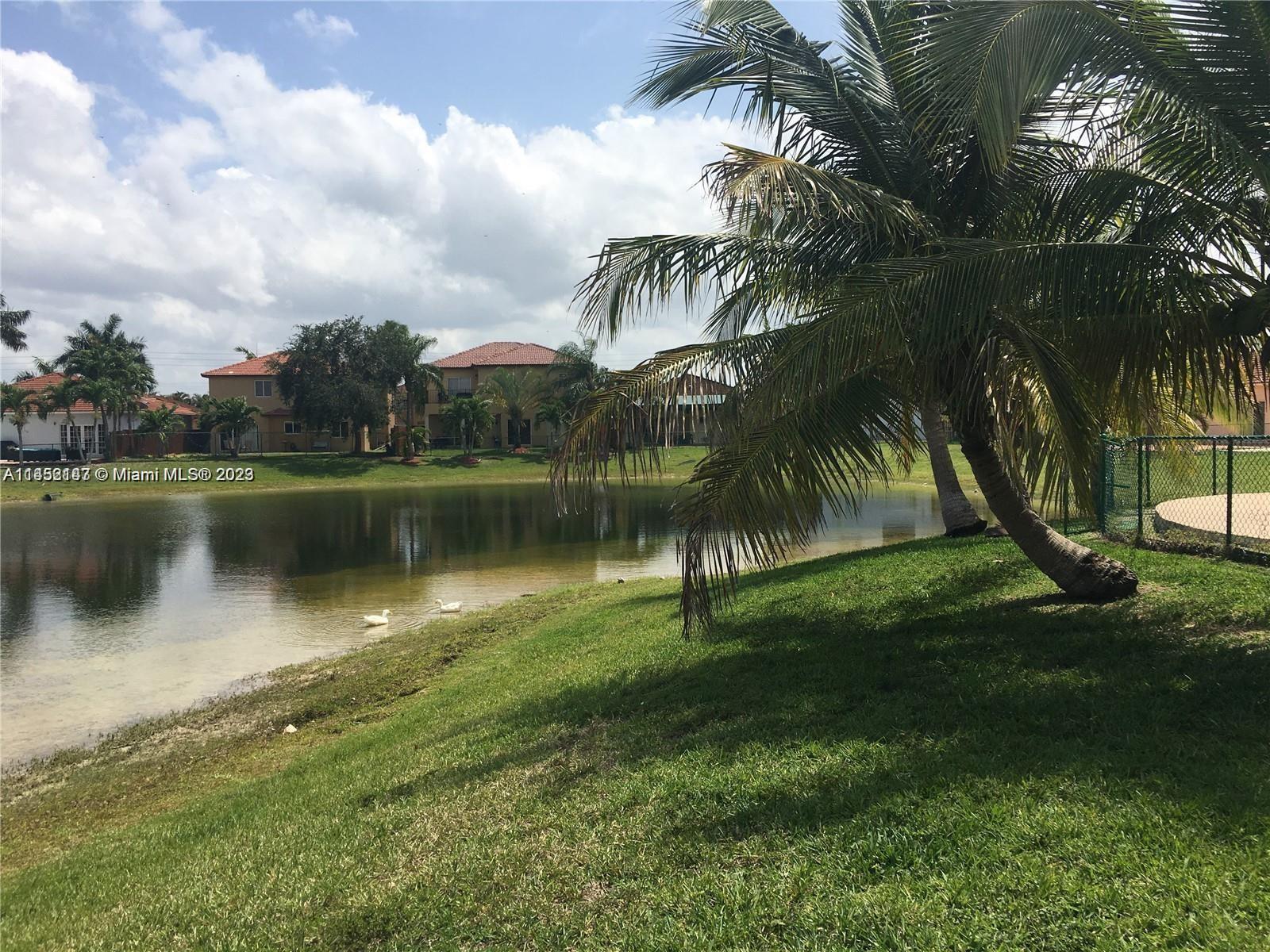 16124 Southwest 55th Terrace Miami, FL 33185 - Photo 2 of 23 a view of a lake with a building in the background