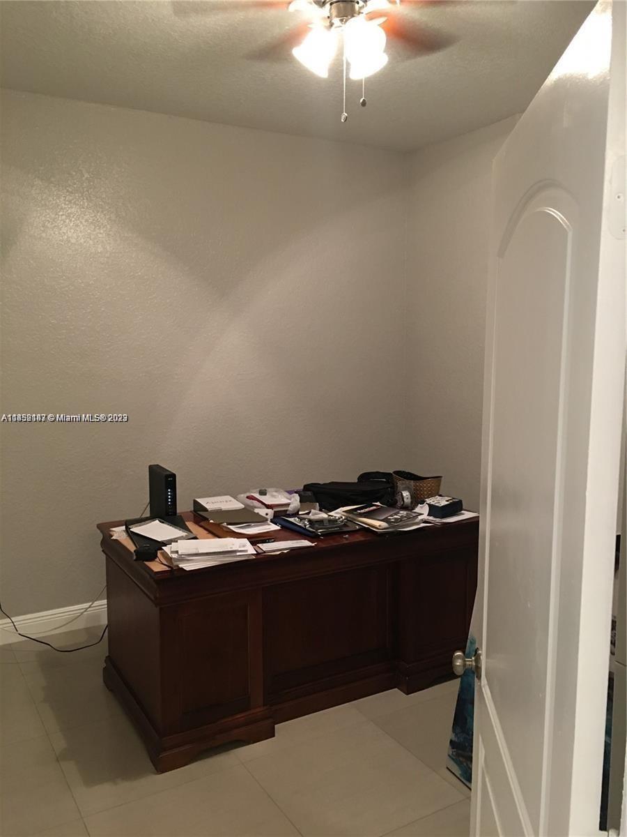 16124 Southwest 55th Terrace Miami, FL 33185 - Photo 21 of 23 a room with a sink a light fixture and a stove