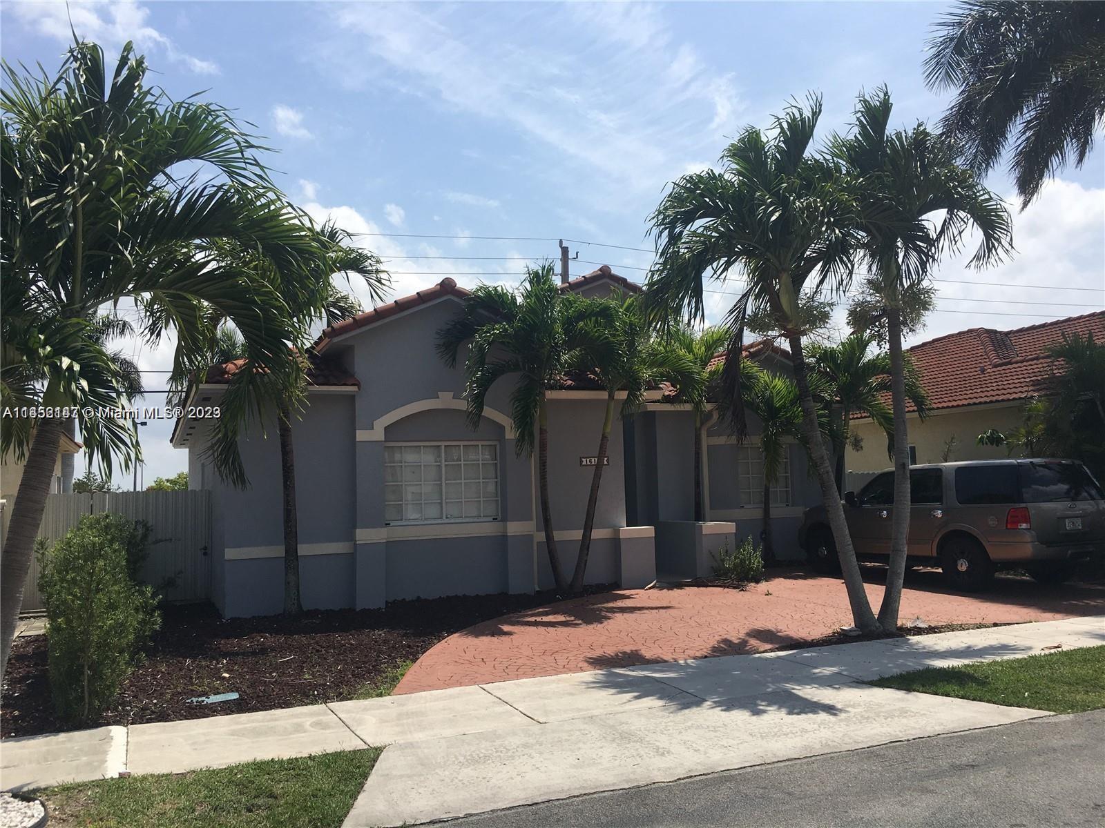 16124 Southwest 55th Terrace Miami, FL 33185 - Photo 3 of 23 a house with palm tree in front of it