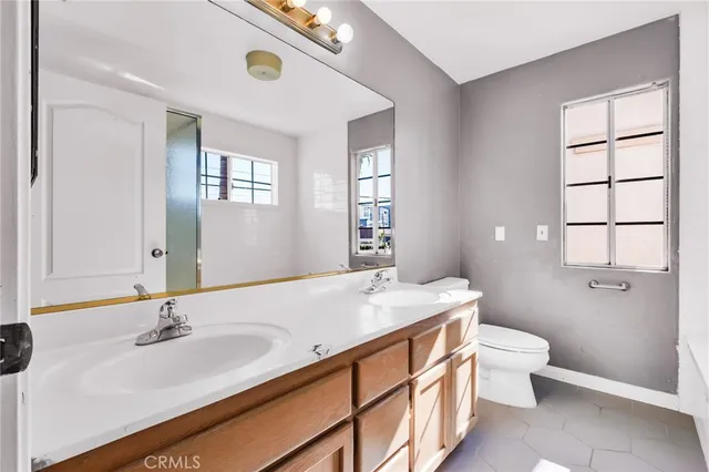 a bedroom with a bed and a potted plant