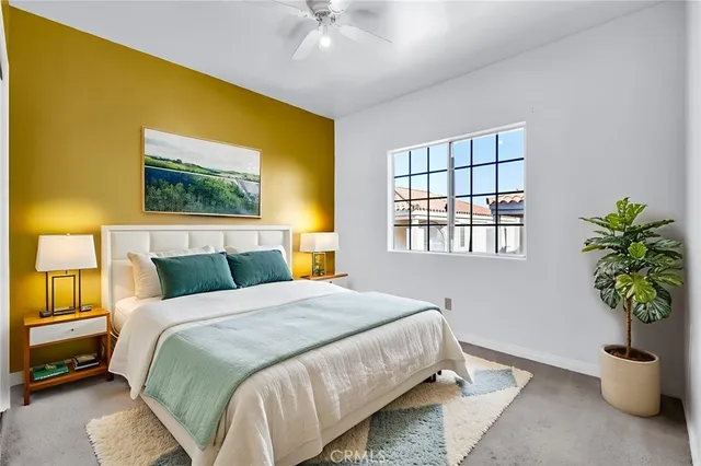 a view of an empty room with a window and a kitchen
