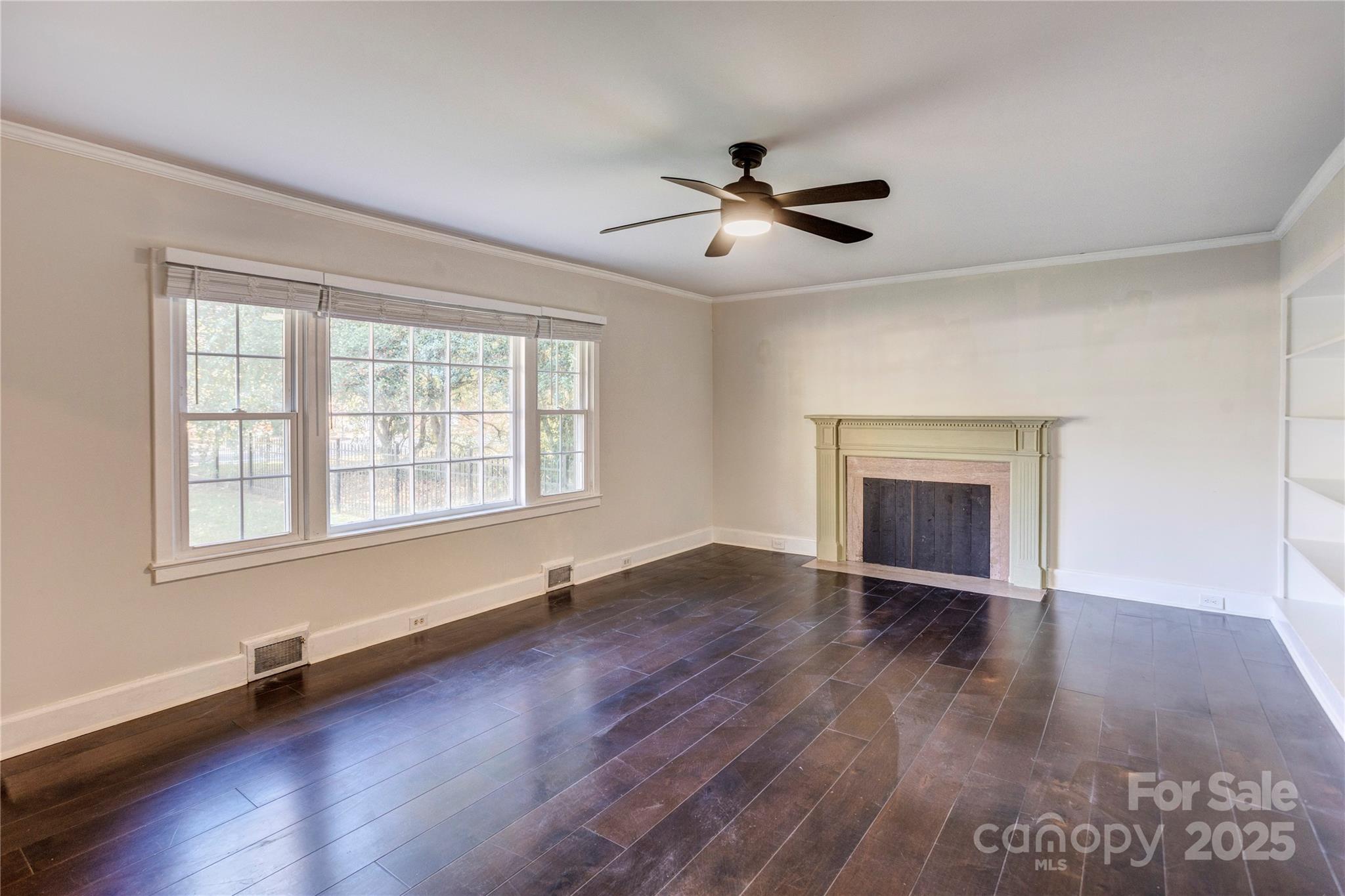 782 Union Street South Concord, NC 28025 - Photo 11 of 19 an empty room with wooden floor fan and windows