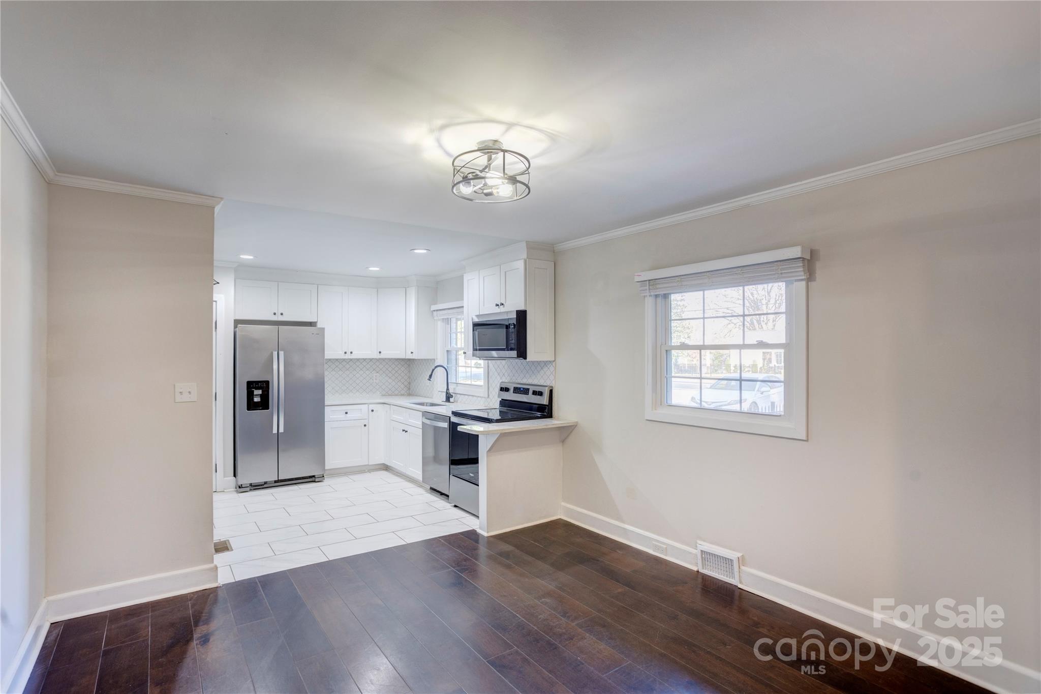782 Union Street South Concord, NC 28025 - Photo 7 of 19 a view of a kitchen with a sink a refrigerator and a stove
