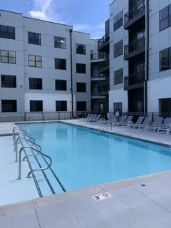 a view of a pathway both side of grassy field with shrub