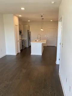 a view of a kitchen with a sink and a refrigerator