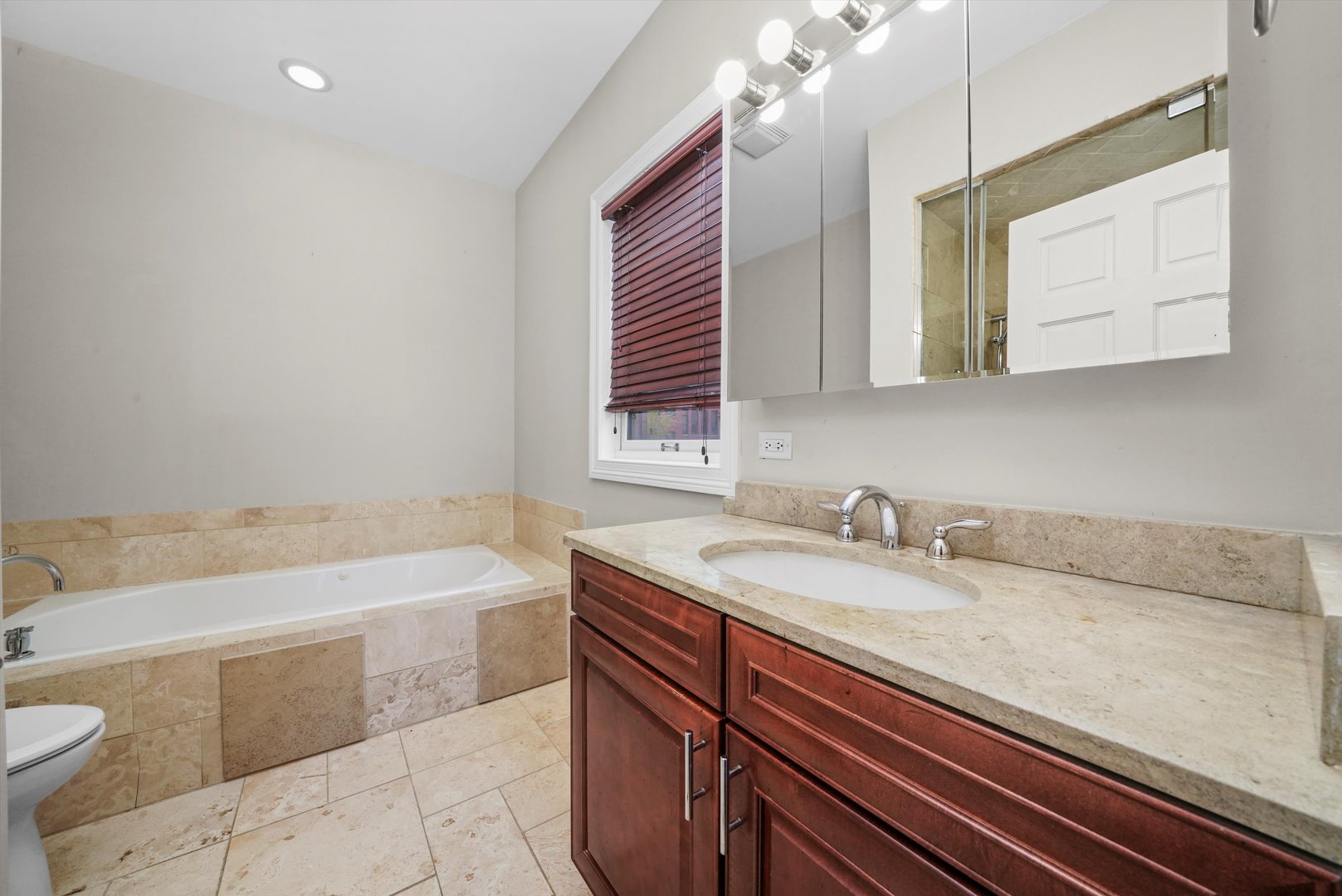 2430 West Iowa Street, Unit 3 Chicago, IL 60622 - Photo 13 of 21 a bathroom with a sink a bathtub and a mirror