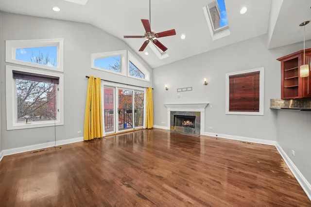 a view of an empty room with a fireplace and a window