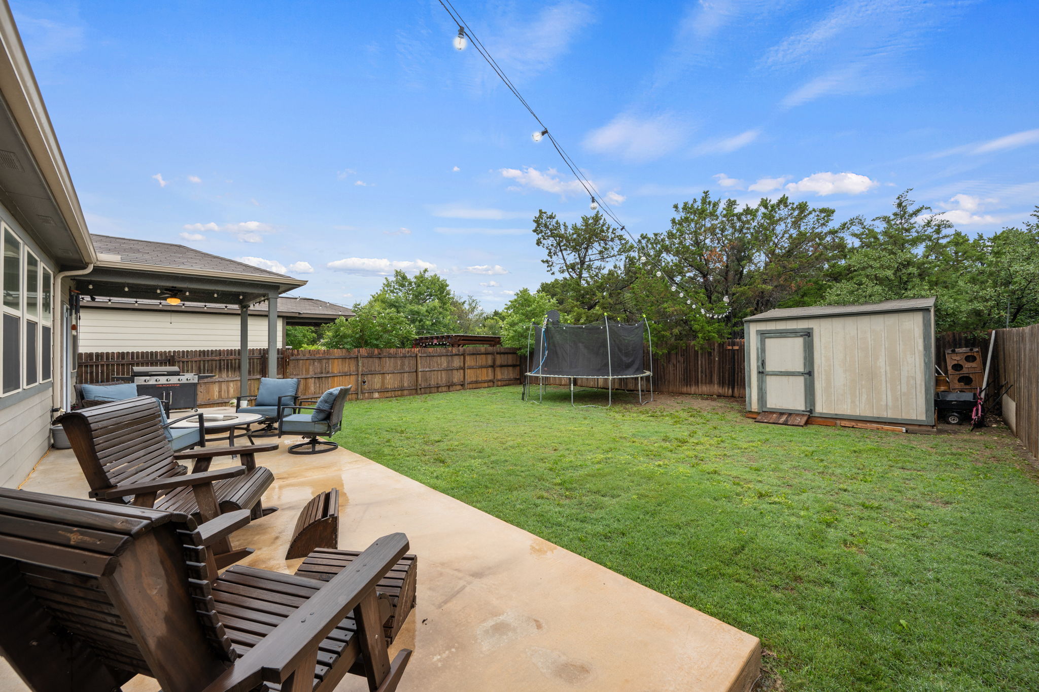 409 Limestone Road Liberty Hill, TX 78642 - Photo 32 of 35 a view of a backyard with sitting area