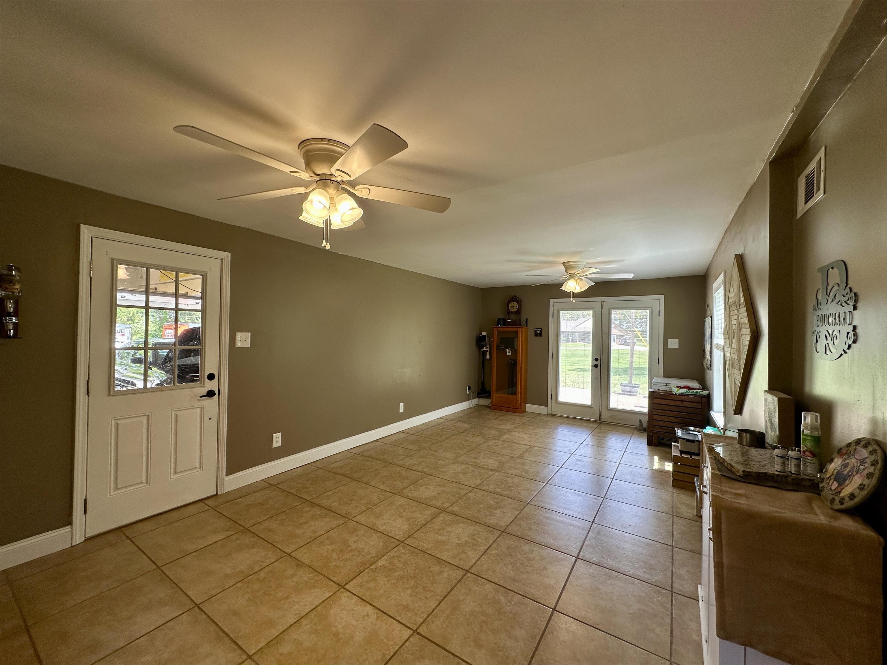 1230 Joann Road Somerville, TN 38068 - Photo 11 of 29 Spacious room featuring tile flooring, multiple ceiling fans, and neutral wall tones