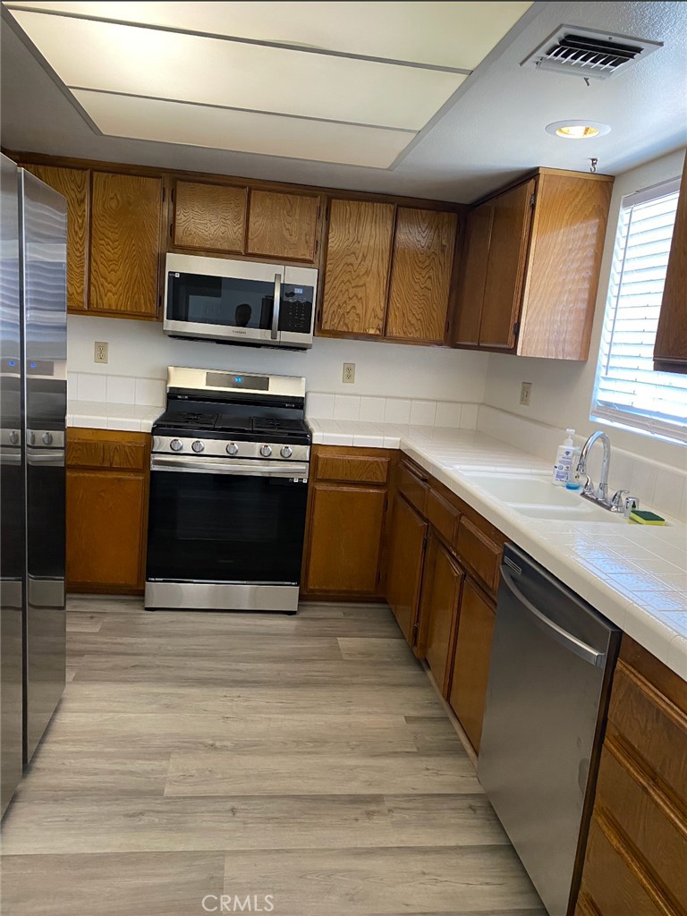 113 Diamond Street Arcadia, CA 91006 - Photo 16 of 24 a kitchen with stainless steel appliances granite countertop a sink and a stove