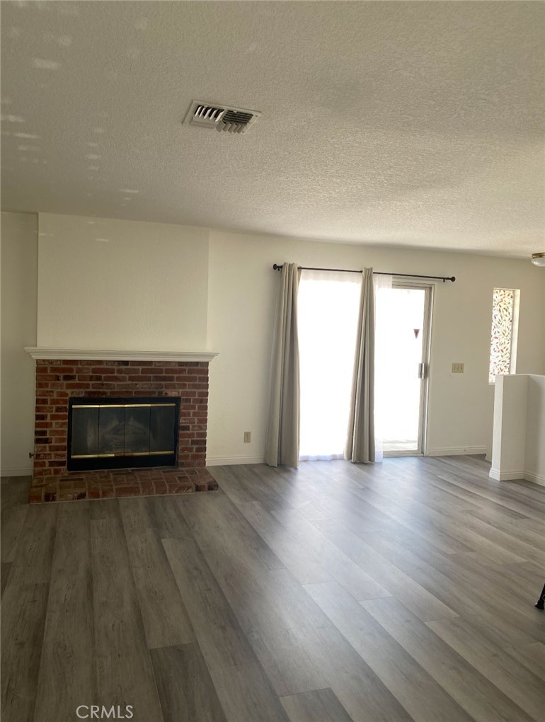 113 Diamond Street Arcadia, CA 91006 - Photo 17 of 24 a view of empty room with wooden floor and fireplace