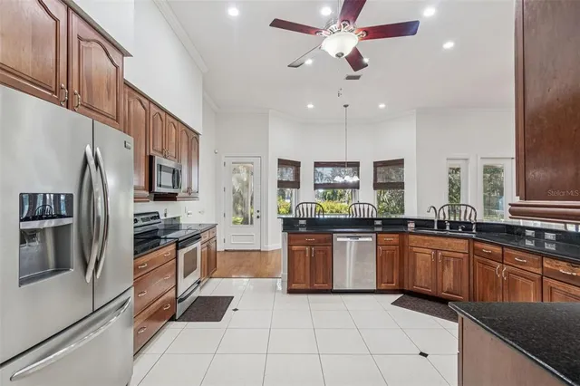 a kitchen with stainless steel appliances granite countertop a sink and stove