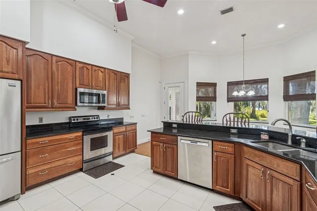 a kitchen with stainless steel appliances granite countertop a sink and cabinets