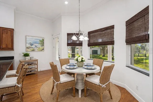 a view of a dining room with furniture wooden floor and a chandelier