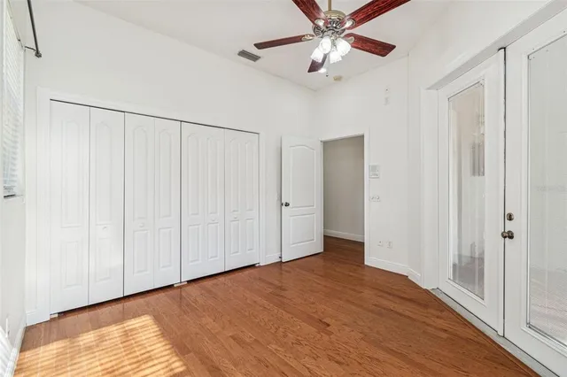 an empty room with wooden floor and window