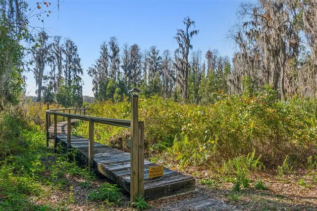 a wooden pier with boats in a lake