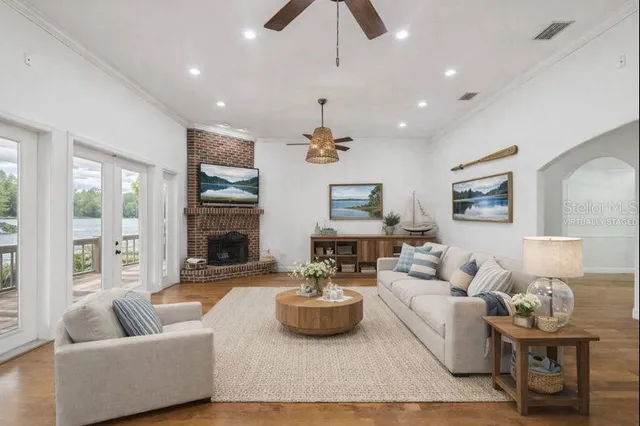 a living room with furniture and a chandelier