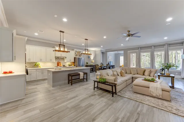 a living room with furniture and kitchen view