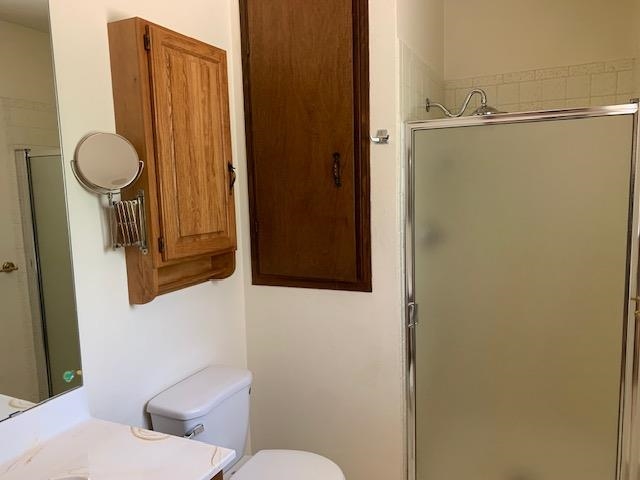 570 Southwest 2nd Court Cedaredge, CO 81413 - Photo 14 of 32 a bathroom with a toilet and a mirror