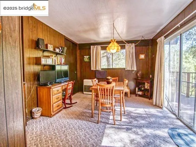 a living room with furniture a flat screen tv and a large window