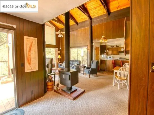 a view of a living room with furniture and floor to ceiling windows