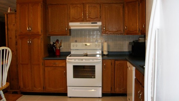 7 Ansie Road Chelmsford, MA 01824 - Photo 8 of 17 a kitchen with wooden cabinets and white appliances