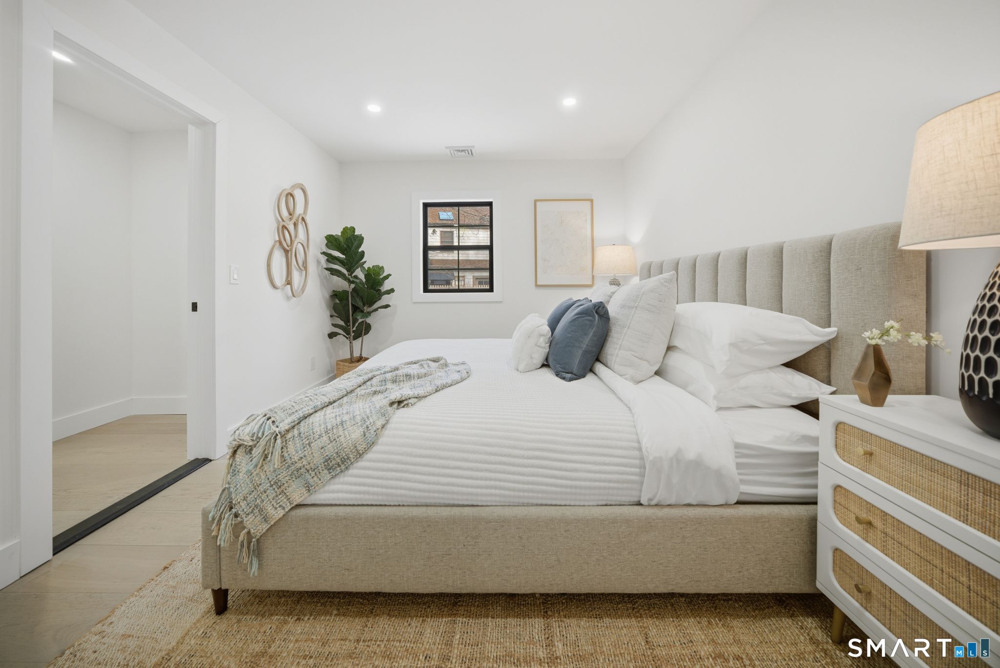 a bedroom with a bed and a lamp