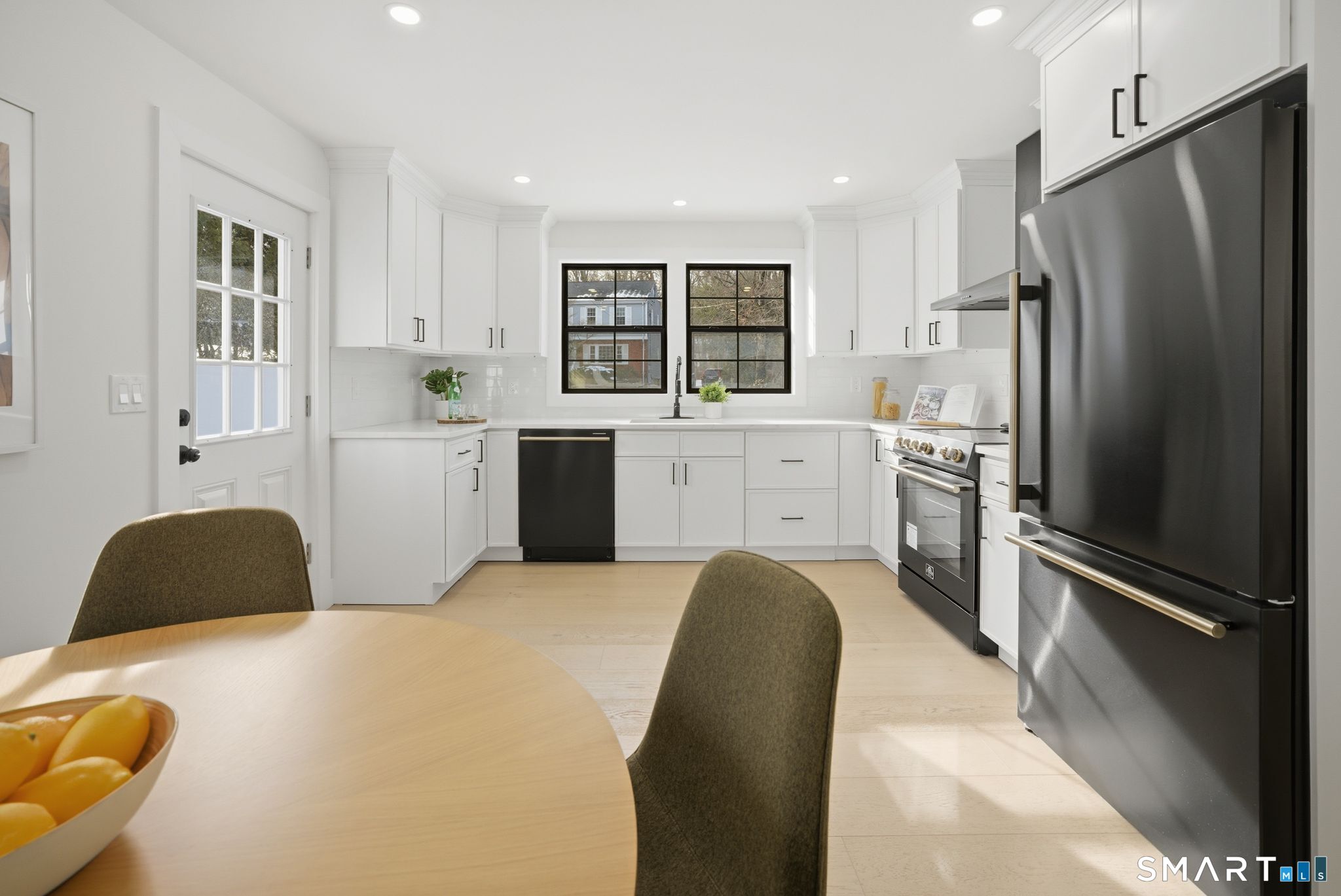101 Parade Hill Road New Canaan, CT 06840 - Photo 6 of 40 a kitchen with stainless steel appliances granite countertop a refrigerator sink and cabinets
