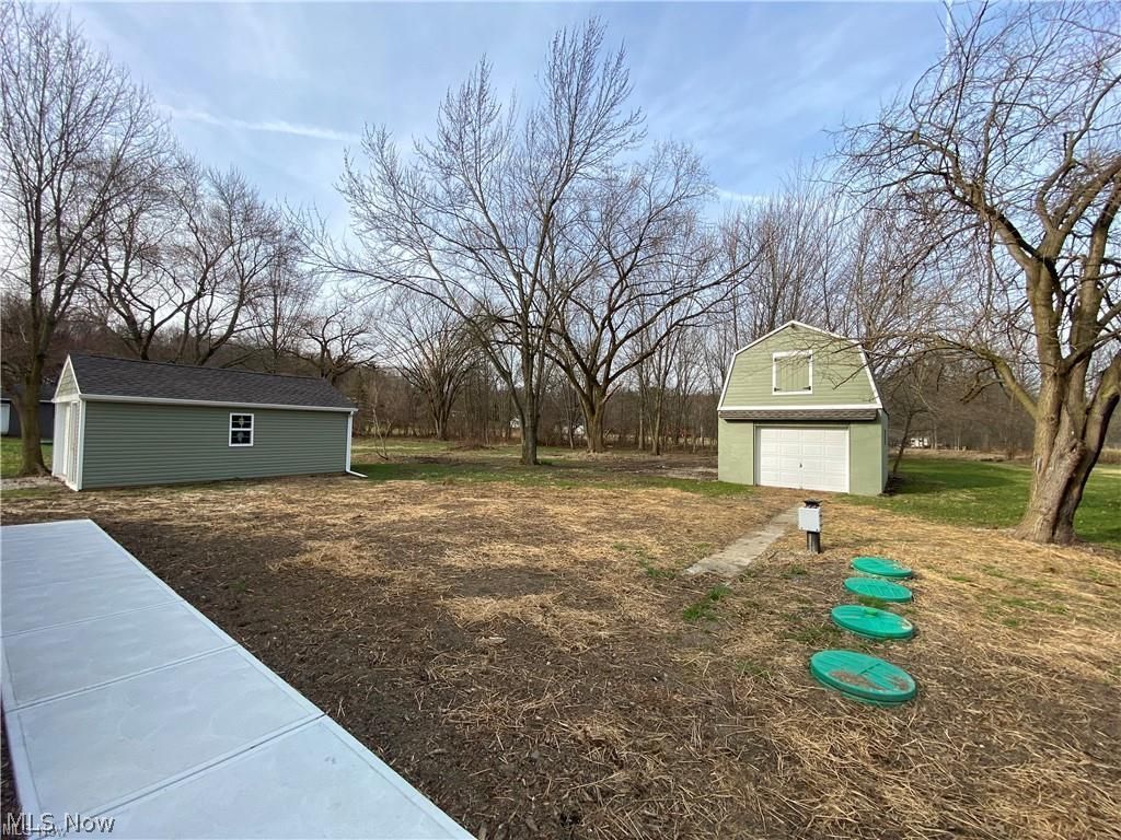 2803 State Road Vermilion, OH 44089 - Photo 7 of 28 View of backyard featuring new concrete, new septic, garage and barn.