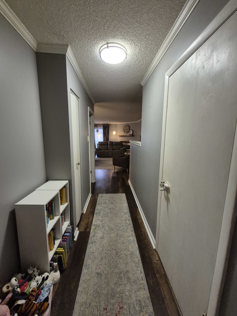 8216 Mulberry Court, Unit 8B Palos Hills, IL 60465 - Photo 13 of 22 a view of a hallway to a livingroom with furniture