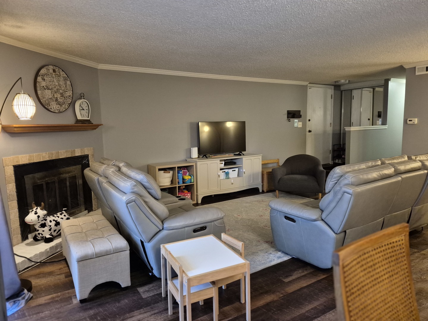 8216 Mulberry Court, Unit 8B Palos Hills, IL 60465 - Photo 17 of 22 a living room with furniture a fireplace and a flat screen tv
