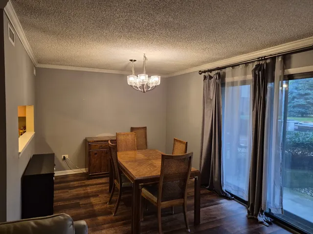 a kitchen with granite countertop a refrigerator and a stove top oven