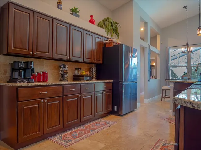 a kitchen with stainless steel appliances granite countertop a refrigerator and cabinets
