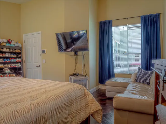 a bedroom with a bed a couch and dresser