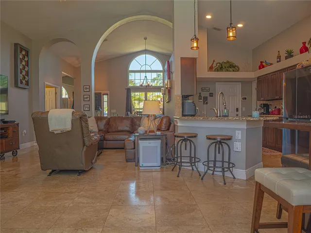 a view of a dining room with furniture and a large window
