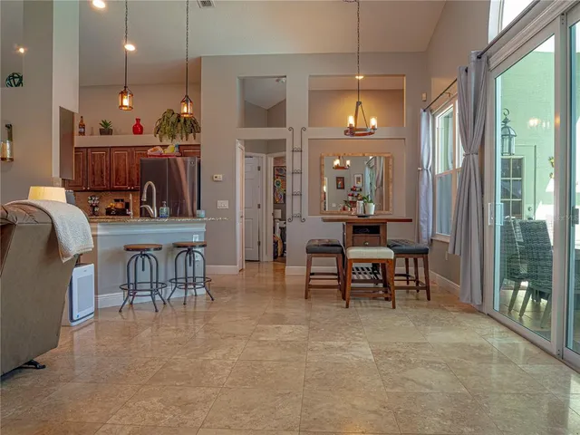 a view of a a dining room with furniture window and outside view
