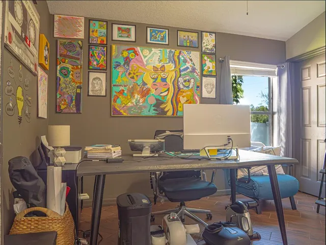 a view of a dining room with furniture and a potted plant